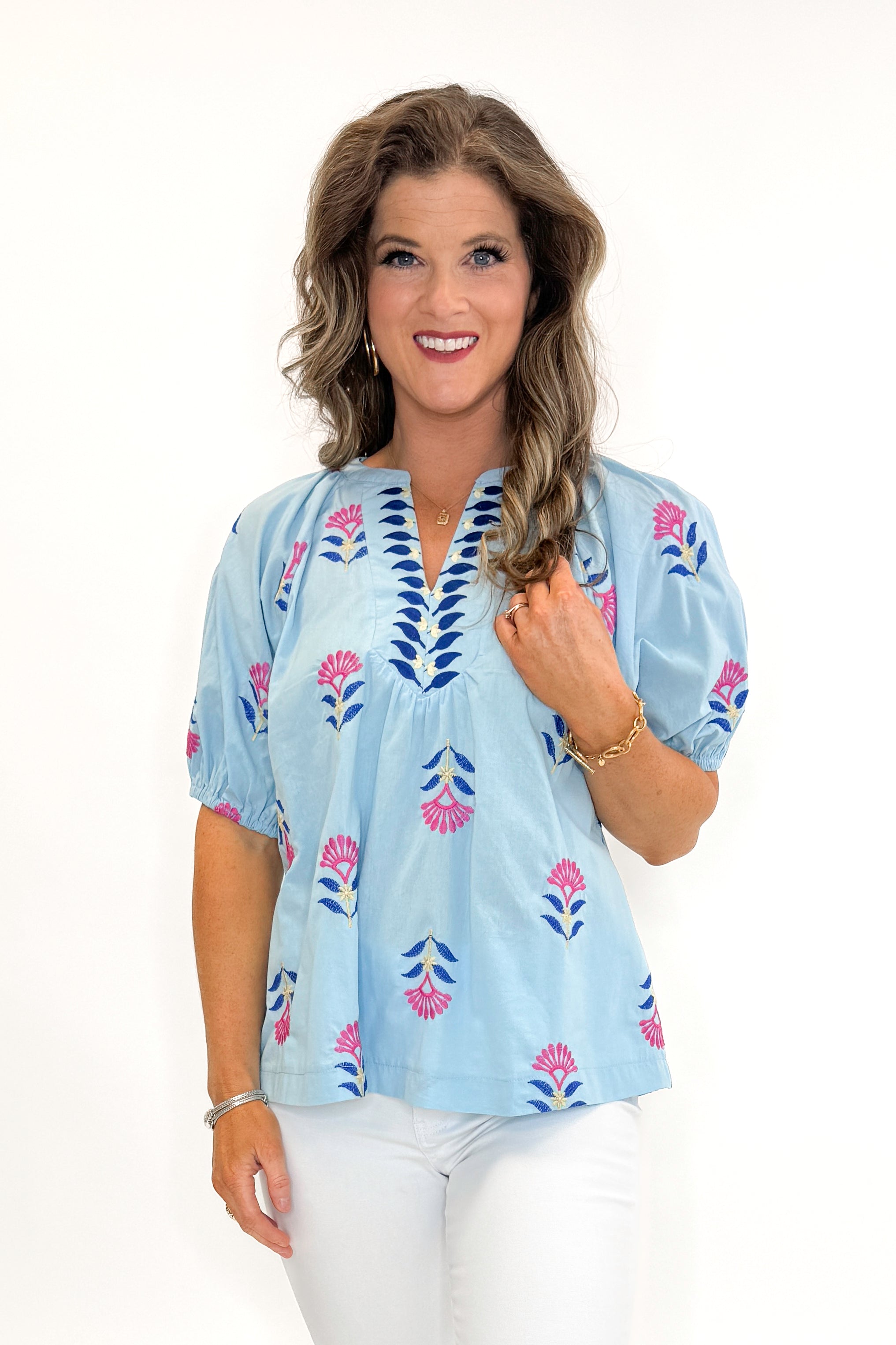 Front view of woman wearing Blue &amp; Multi Floral Embroidered Top with jeans against white studio background.