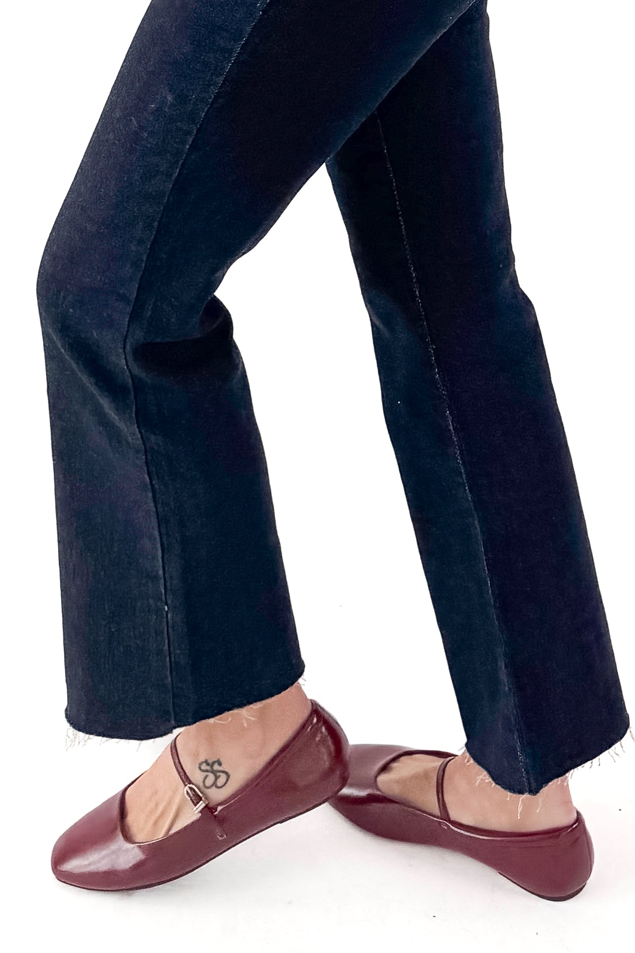 Red shoes and jeans on a white background .