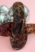 Kate- Tortoise Flip Flops against a pink background close up
