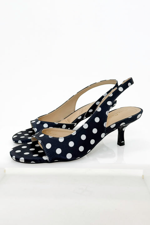 Keep- Black &amp; White Polka Dot Kitten Heels against white studio background side view.
