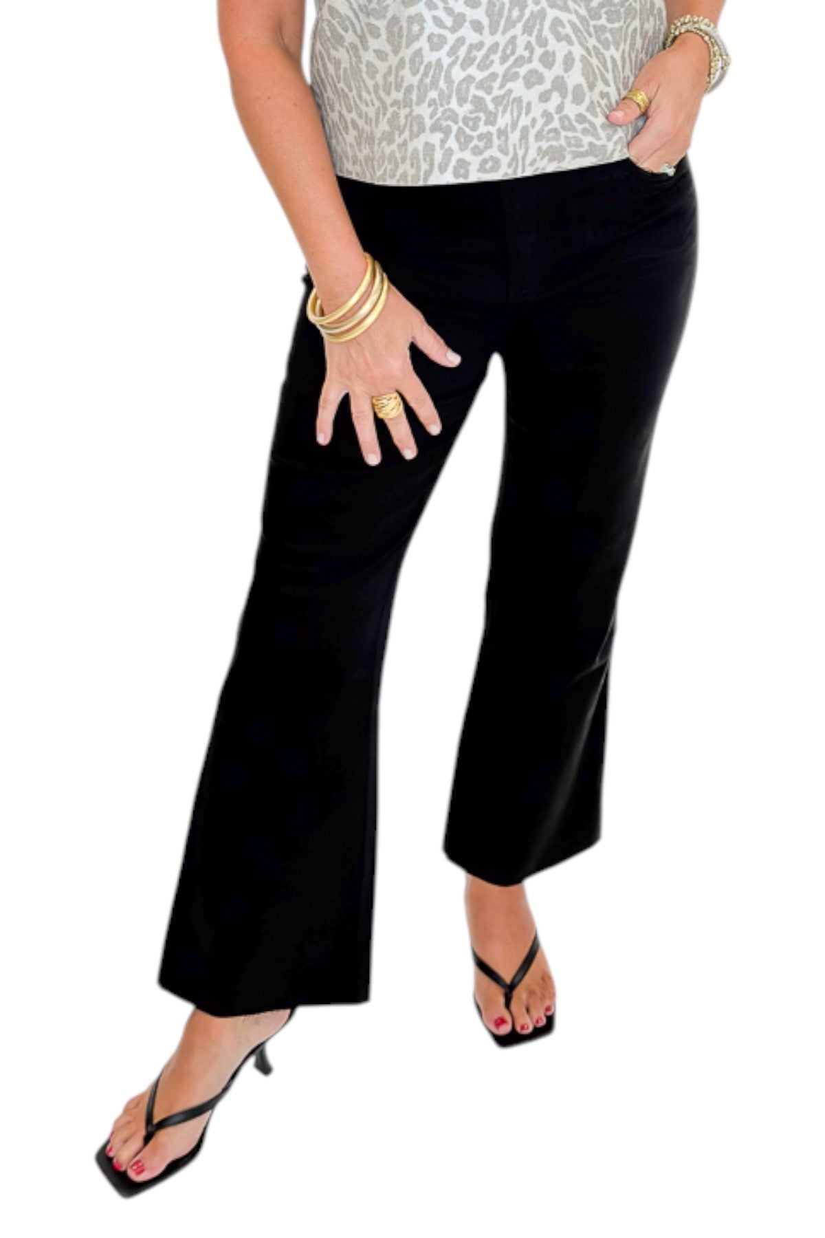 Front view of woman wearing Swagger Boutique’s Kelsey Ankle Flare Jeans In Black by Kut from the Kloth with top against white studio background.