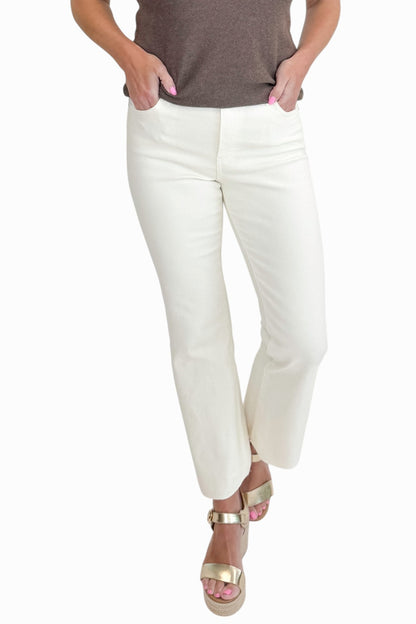 Front view of woman wearing Swagger Boutique’s Kelsey Ankle Flare Jeans In Ecru by Kut from the Kloth with top against white studio background.