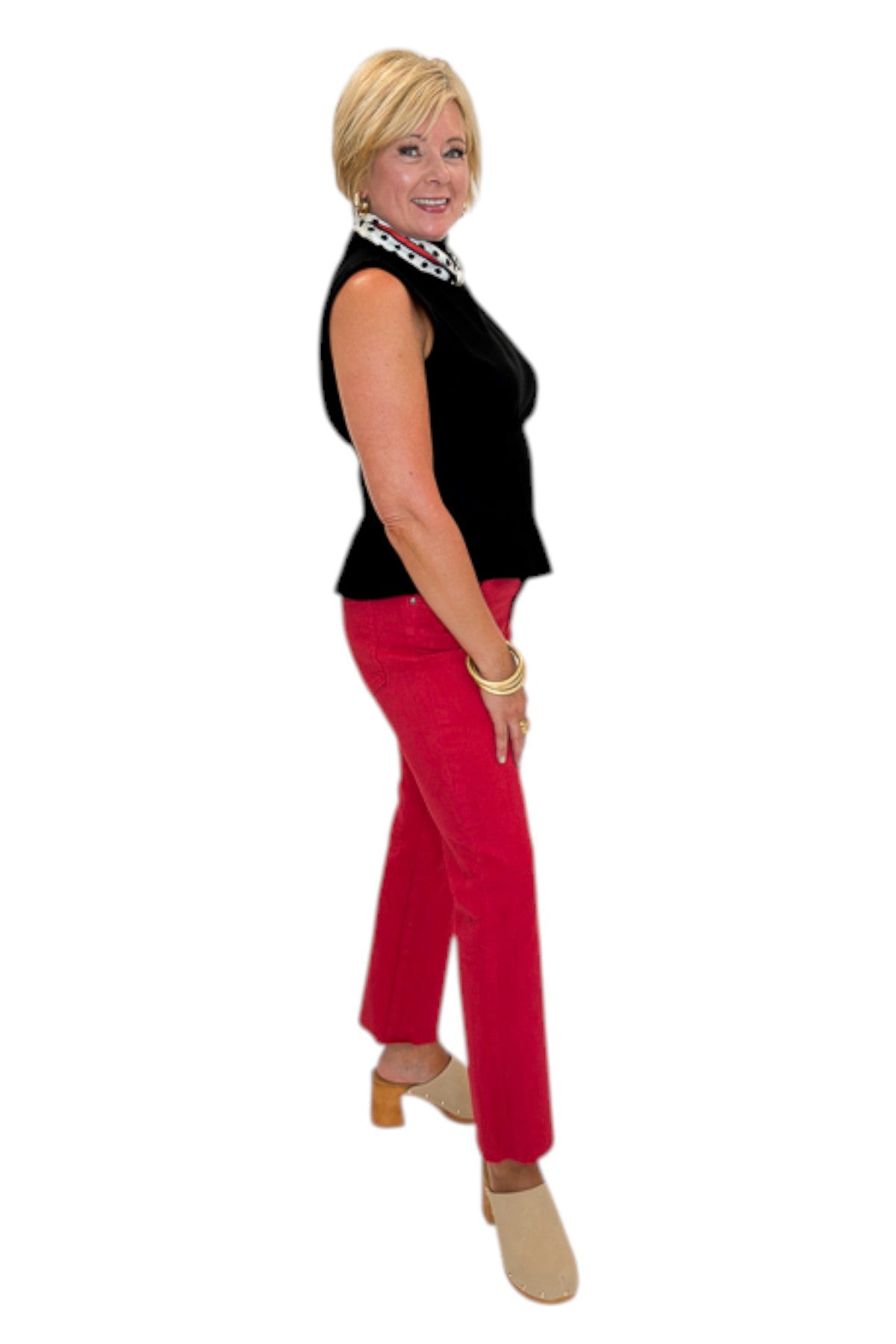 Side view of woman wearing Swagger Boutique’s Kelsey Ankle Flare Jeans In Ruby Red by Kut from the Kloth with black top against white studio background.