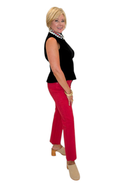 Side view of woman wearing Swagger Boutique’s Kelsey Ankle Flare Jeans In Ruby Red by Kut from the Kloth with black top against white studio background.
