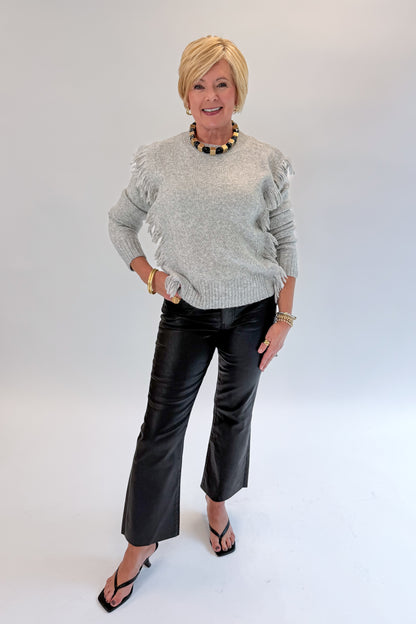 Front view of woman wearing Swagger Boutique’s Kelsey Coated Ankle Flare Jeans in Black by Kut from the Kloth against white studio background.