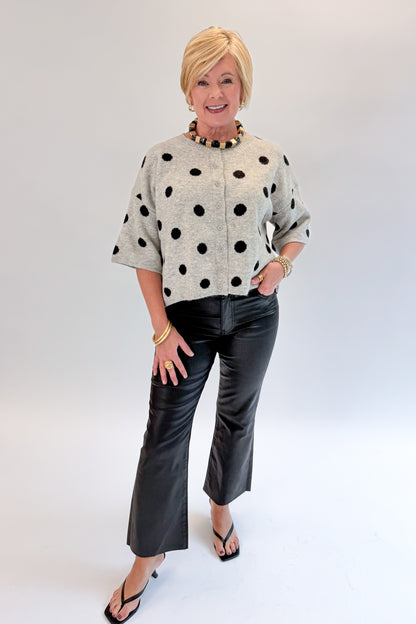 Front view of woman wearing Swagger Boutique’s Kelsey Coated Ankle Flare Jeans in Black by Kut from the Kloth against white studio background.