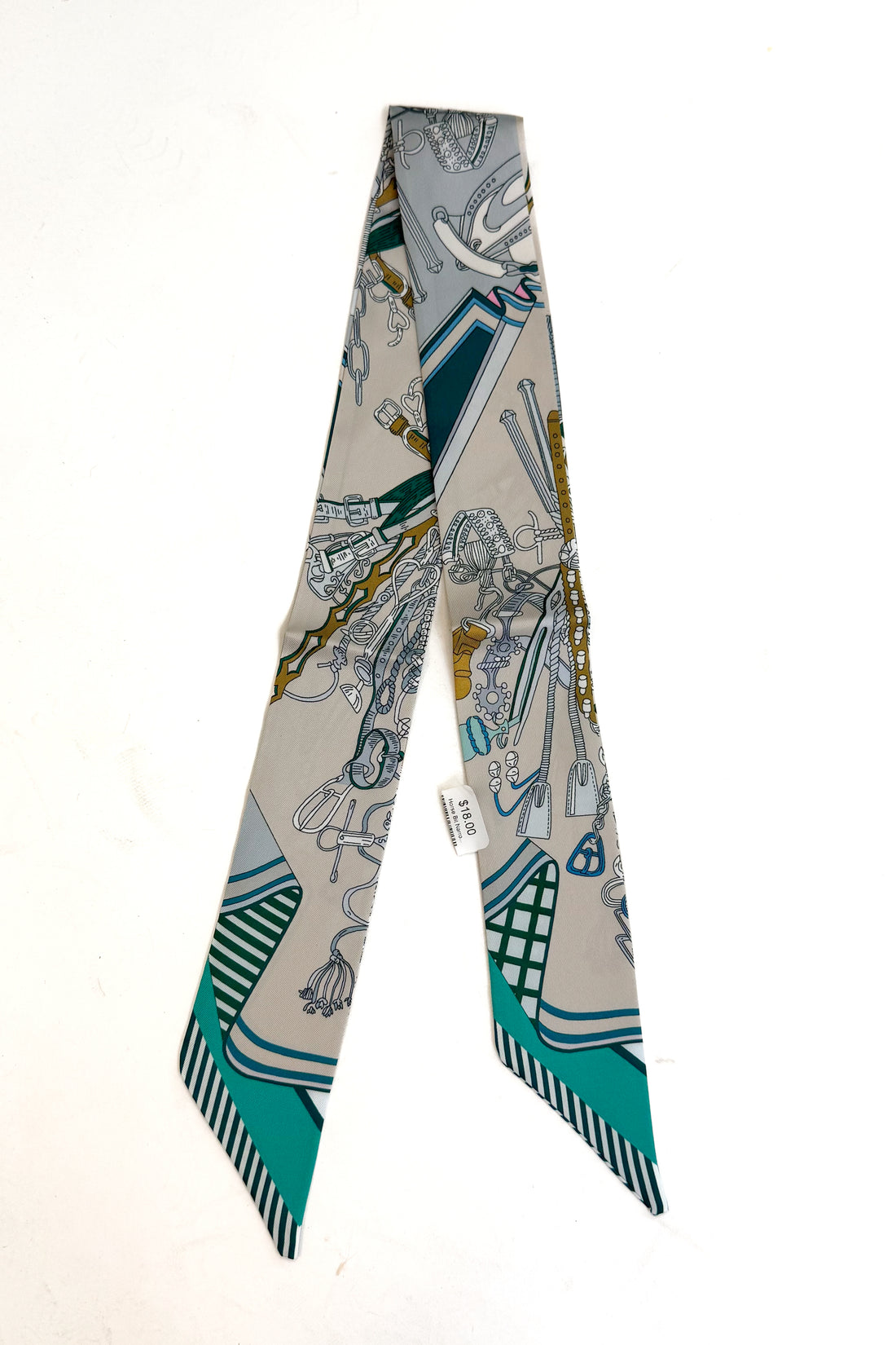 blue and cream scarf featuring horse bit design on white background