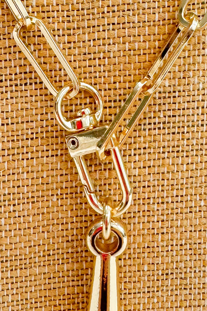 Gold metal clip on a textured brown background