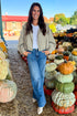 Front view of woman wearing Swagger Boutique’s Khaki Bubble Hem Bomber Jacket with jeans at a pumpkin patch.