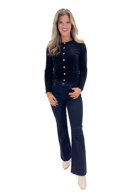 Front view of woman wearing Black With Rhinestone Buttons Eyelash Cardigan with jeans against white studio background. 