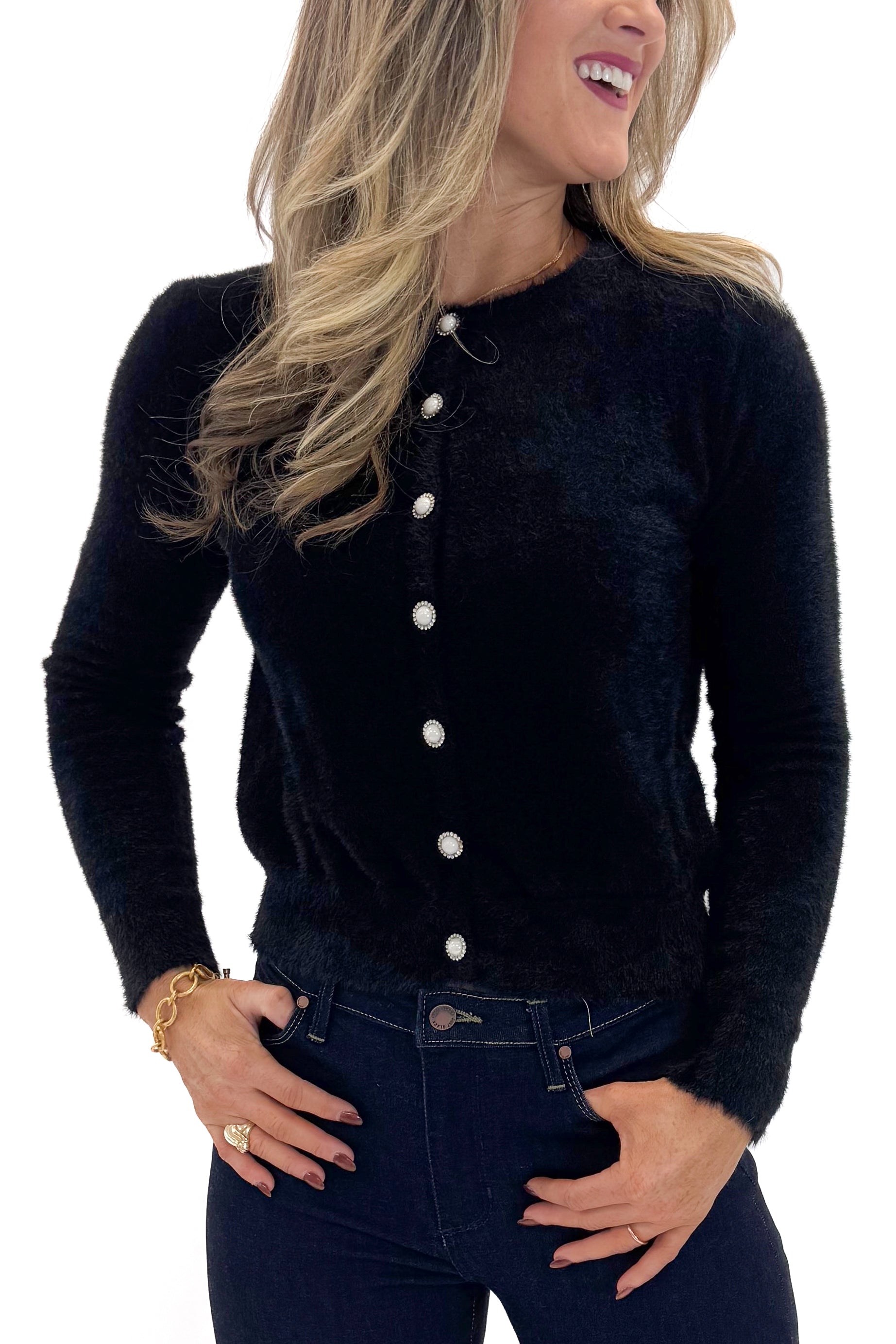 Front detail view of woman wearing Black With Rhinestone Buttons Eyelash Cardigan with jeans against white studio background. 
