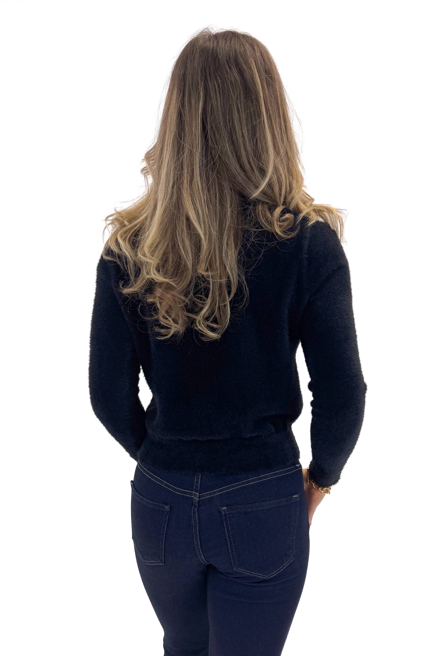 Back view of woman wearing Black With Rhinestone Buttons Eyelash Cardigan with jeans against white studio background. 