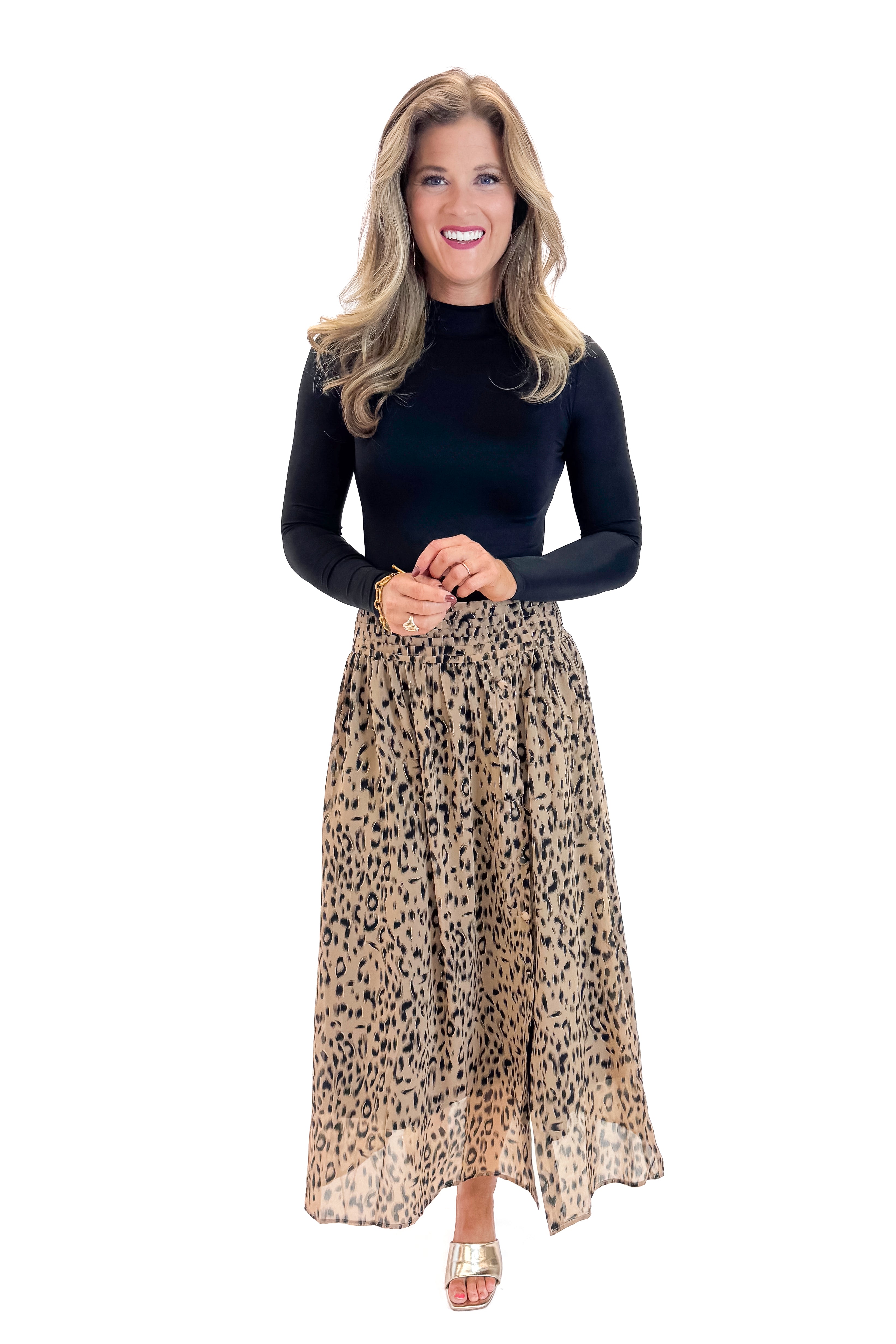 Front view of woman wearing black top with Beige Leopard Button Detail Skirt against white studio background.