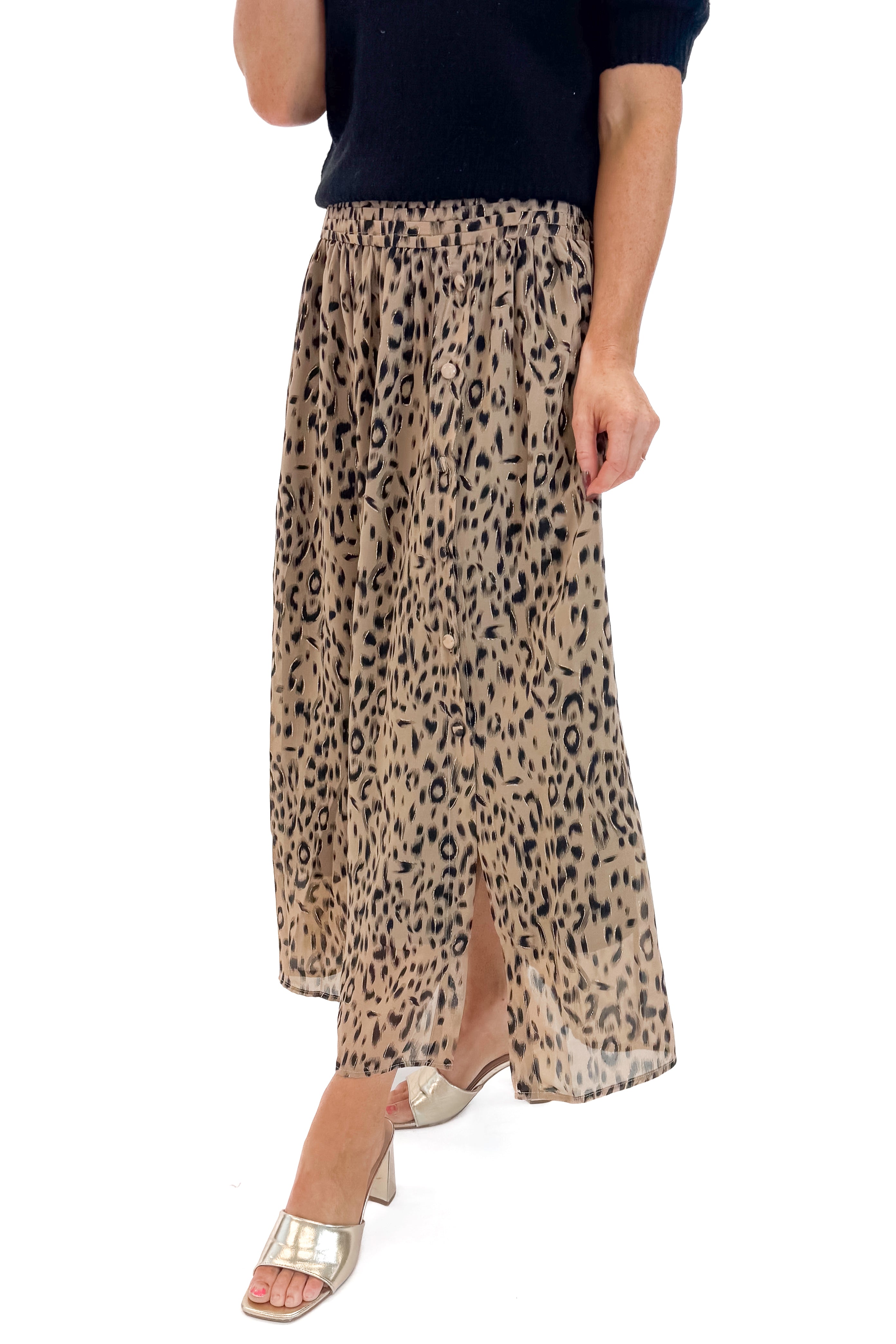 Front detail view of woman wearing black sweater with Beige Leopard Button Detail Skirt against white studio background.