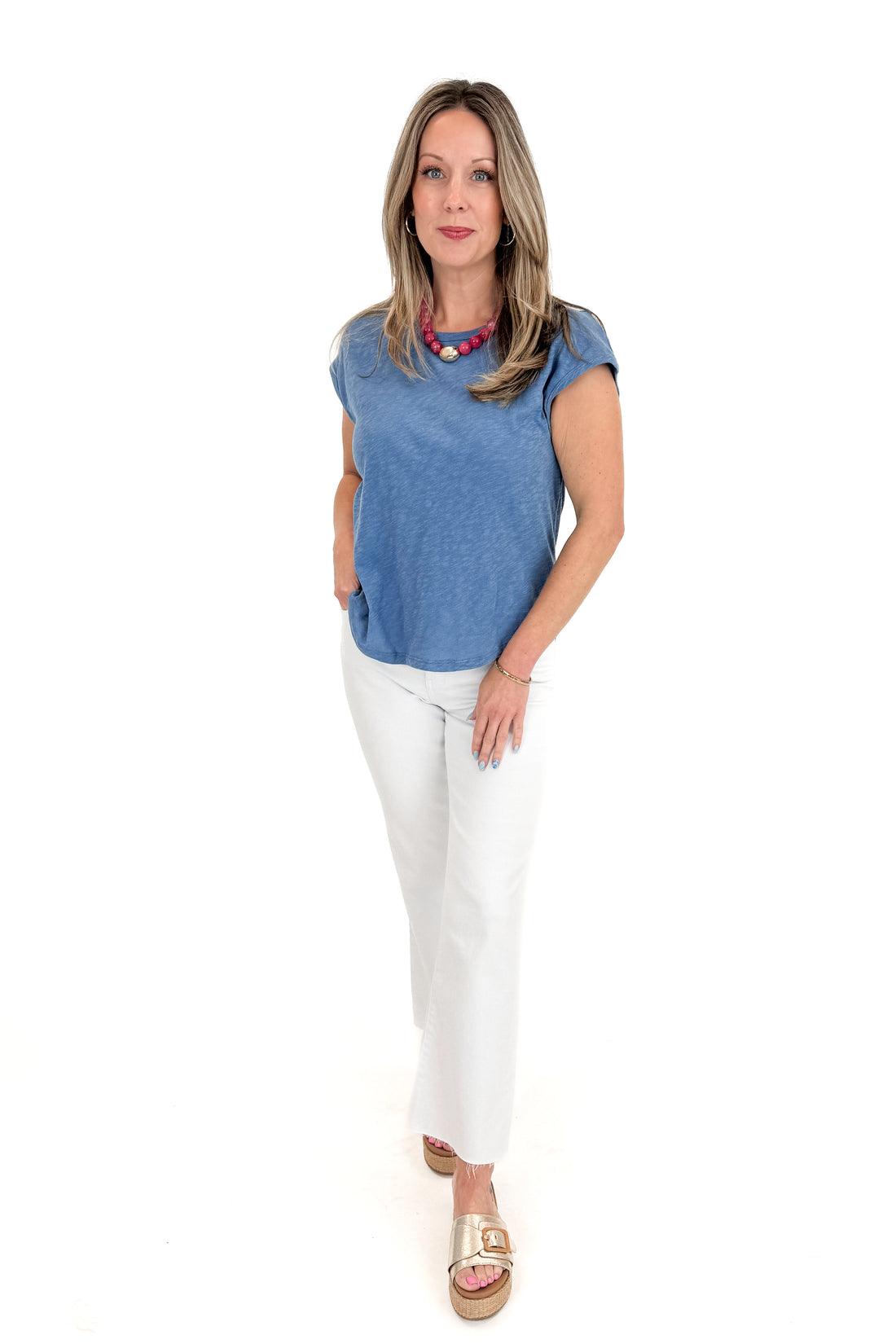 Front view of woman wearing Lake Blue Sol Slub Tank by Z Supply with jeans against white studio background.