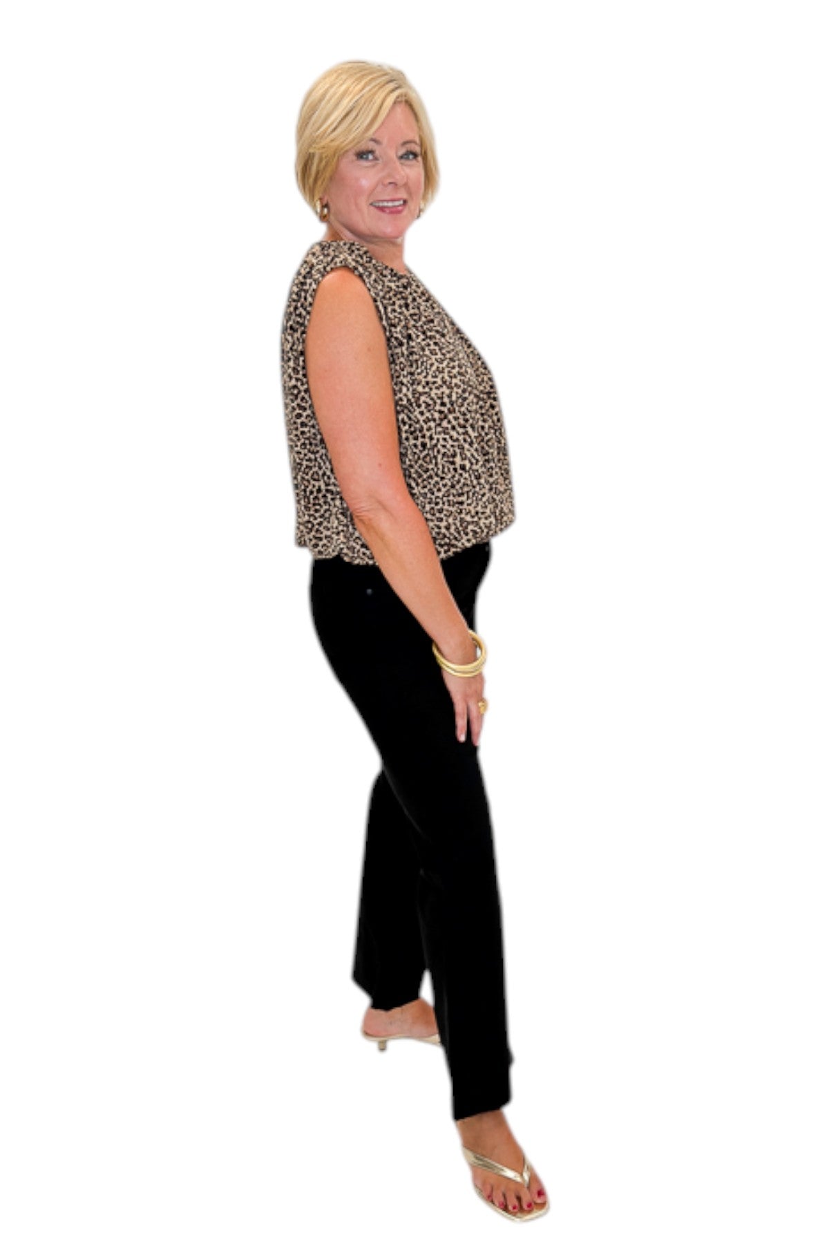 Side view of woman wearing Swagger Boutique’s Leopard Bubble Hem Top with jeans against white studio background.