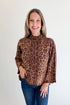 Front view of woman wearing Swagger Boutique’s Leopard Print Mock Neck Sweater by Entro with jeans against white studio background.