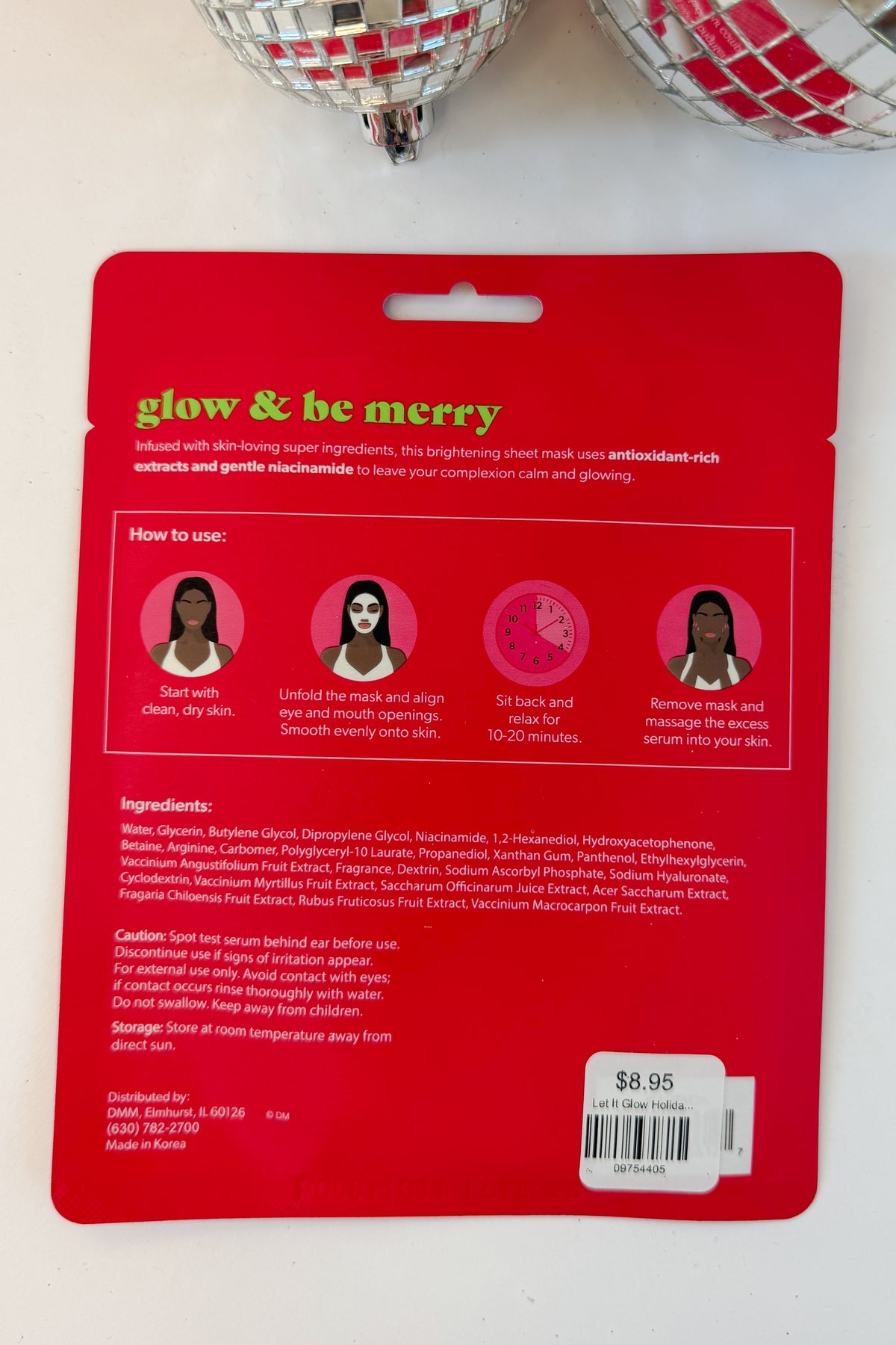 Let It Glow Holiday Face Mask against holiday background.