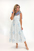 Front view of woman wearing Swagger Boutique’s Light Blue Printed Midi Dress With Tie Straps by Entro with heels against white studio background.