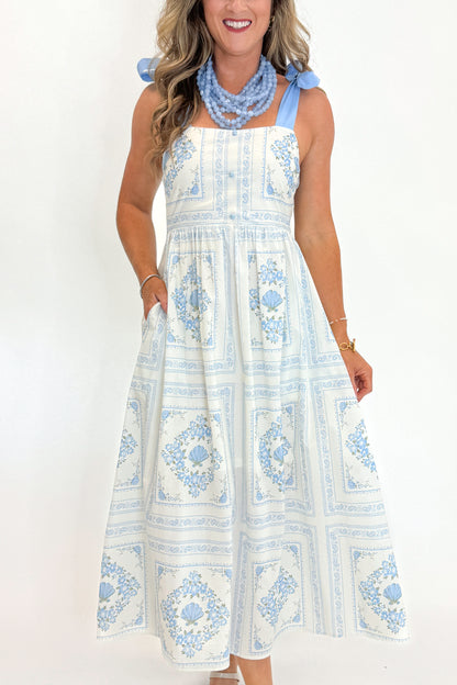 Front view of woman wearing Swagger Boutique’s Light Blue Printed Midi Dress With Tie Straps by Entro with heels against white studio background.