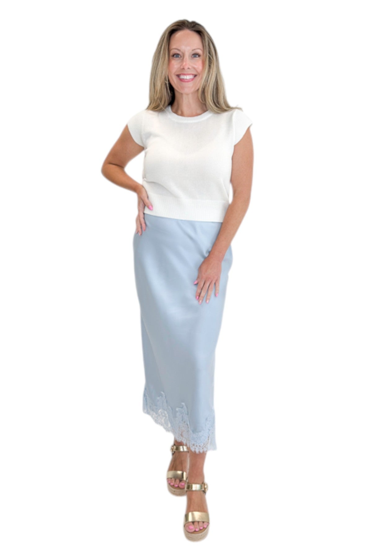 Front view of woman wearing Swagger Boutique’s Light Blue Satin &amp; Lace Midi Skirt with sweater against white studio background.