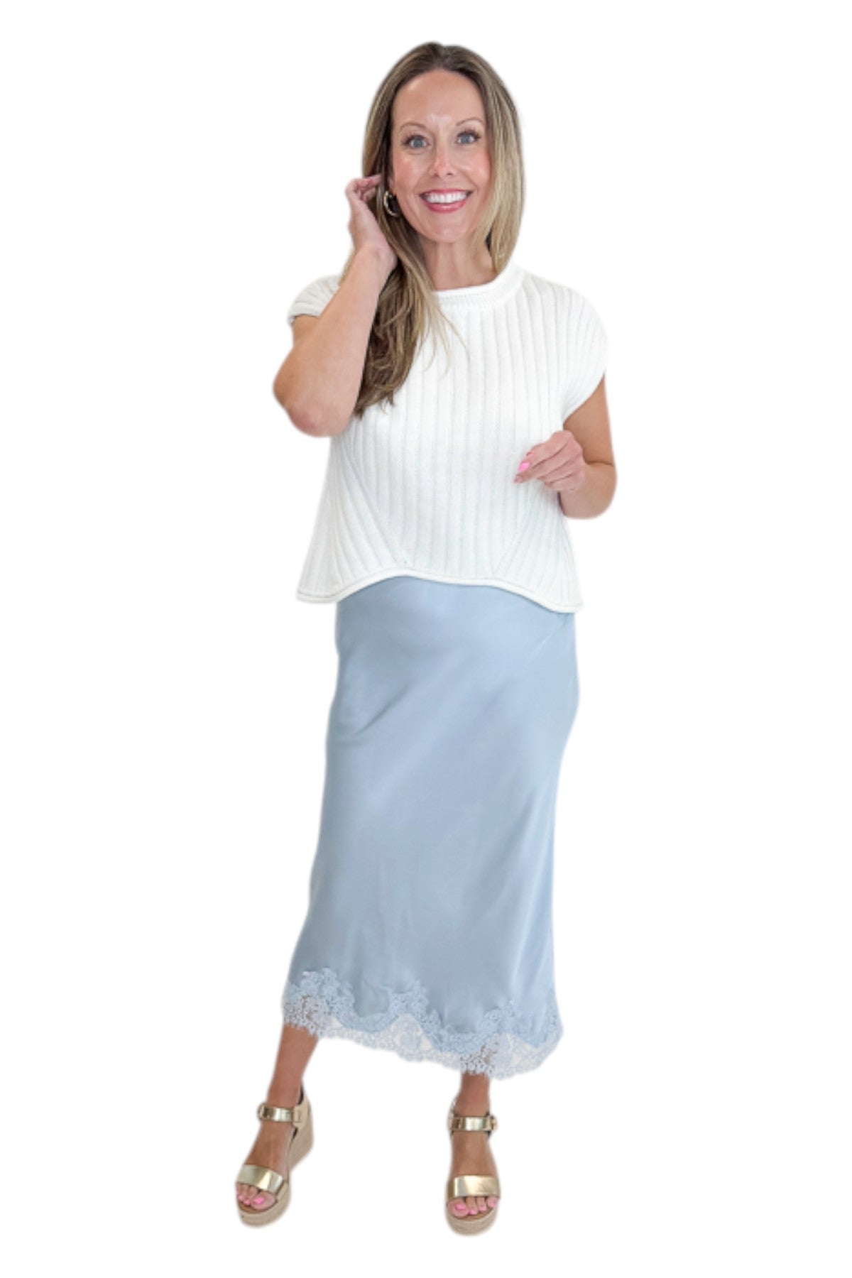 Front view of woman wearing Swagger Boutique’s Light Blue Satin &amp; Lace Midi Skirt with sweater against white studio background.
