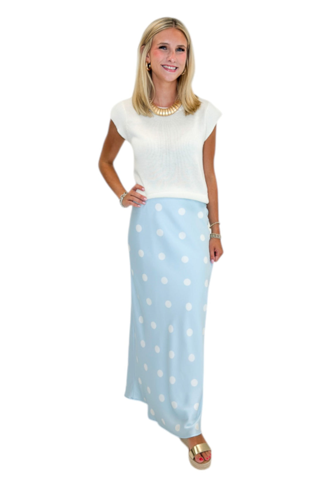 Front view of woman wearing Swagger Boutique’s Light Blue &amp; White Polka Dot Satin Skirt with white top against white studio background.