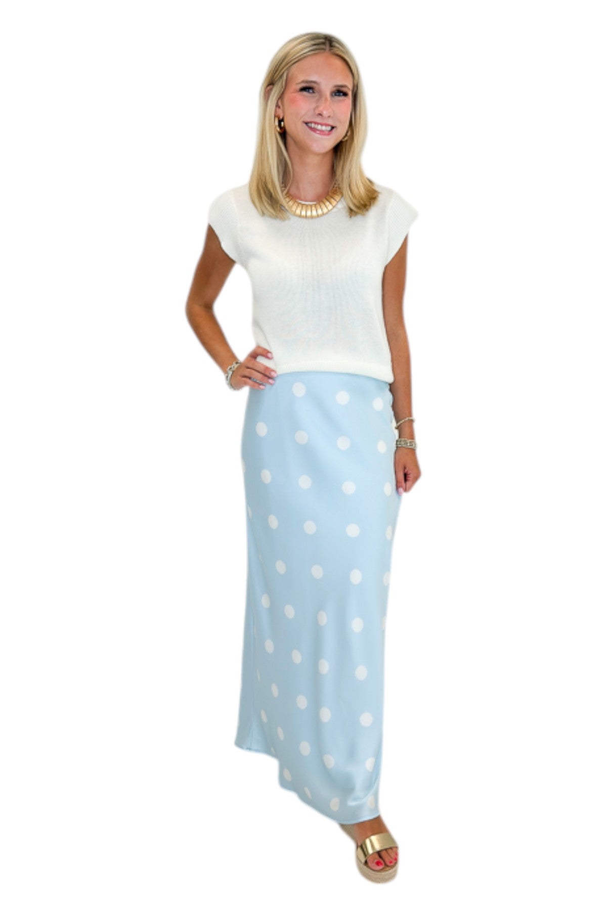 Front view of woman wearing Swagger Boutique’s Light Blue &amp; White Polka Dot Satin Skirt with white top against white studio background.