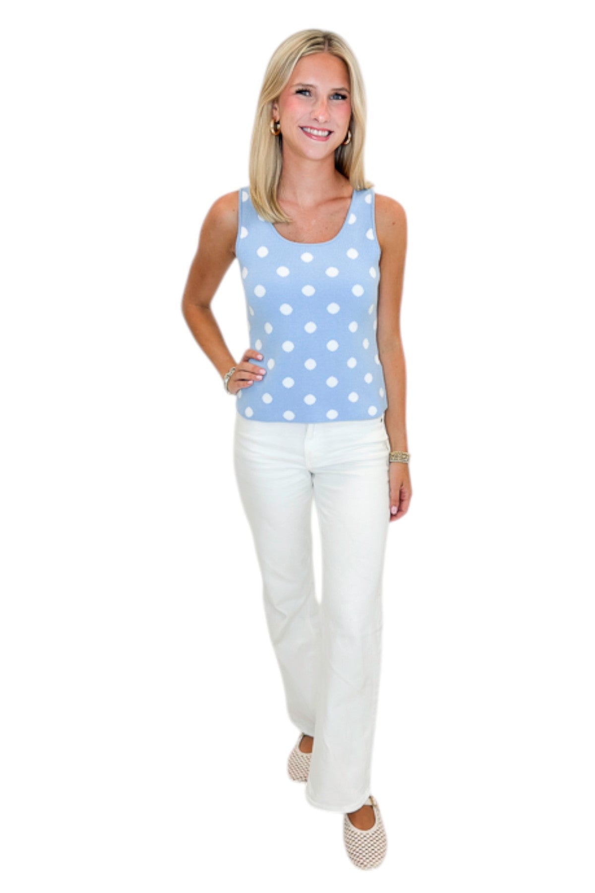 Front view of woman wearing Swagger Boutique’s Light Blue &amp; White Polka Dot Sweater Tank with jeans against white studio background.