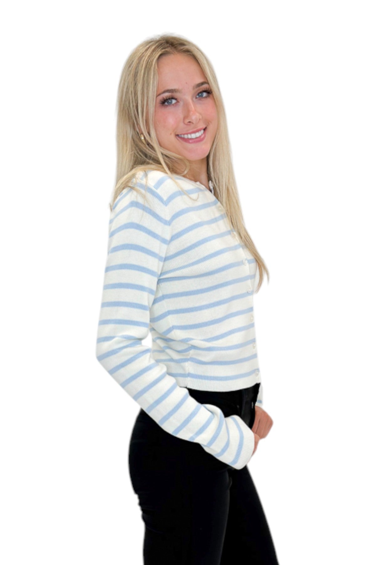 Side view of woman wearing Swagger Boutique’s Light Blue &amp; White Striped Button Up Cardigan with jeans against white studio background.