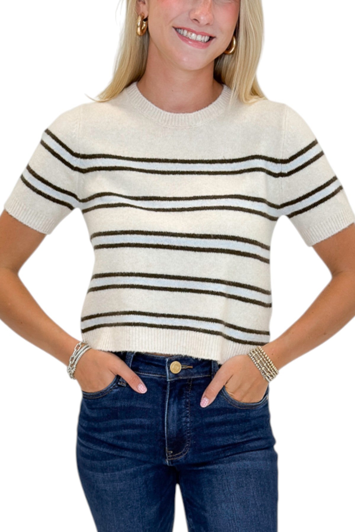 Front detail view of woman wearing Swagger Boutique’s Light Oatmeal Heather Gatewood Stripe Sweater by Z Supply with jeans against white studio background.