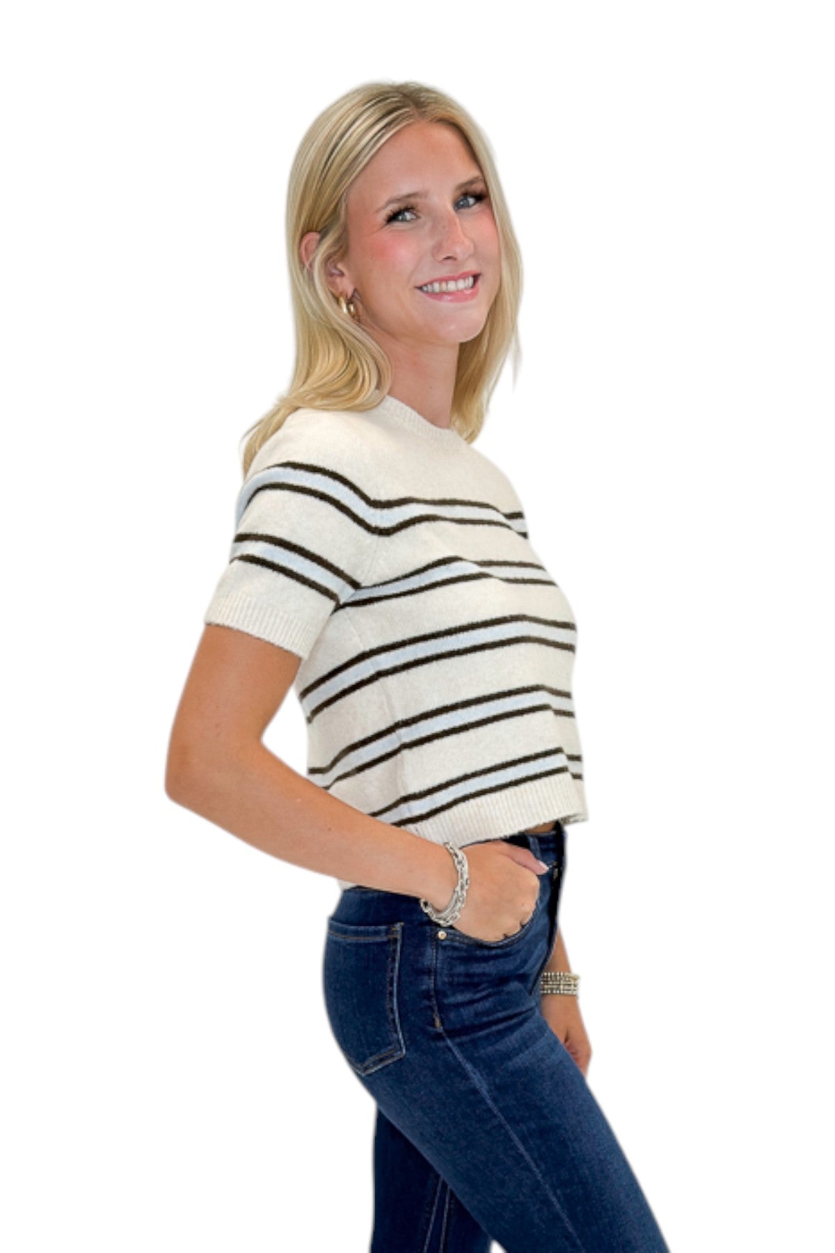 Side view of woman wearing Swagger Boutique’s Light Oatmeal Heather Gatewood Stripe Sweater by Z Supply with jeans against white studio background.
