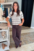 Front view of woman wearing Swagger Boutique’s Light Oatmeal Heather Gatewood Stripe Sweater by Z Supply with jeans standing at the store.