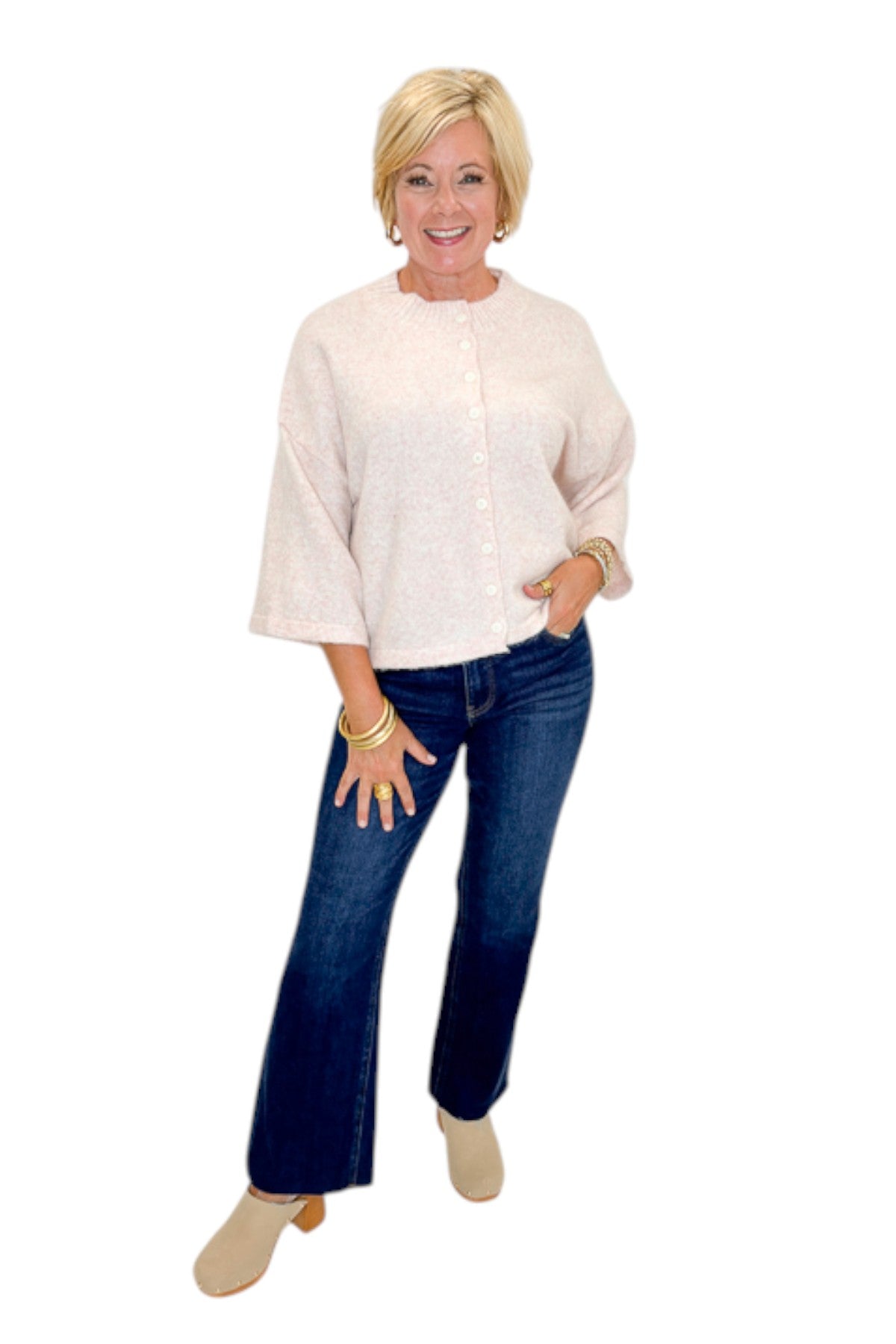Front view of woman wearing Swagger Boutique’s Light Pink Button Up Short Sleeve Cardigan with jeans against white studio background.