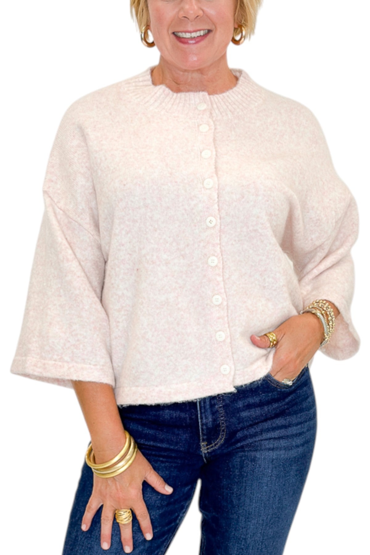 Front detail view of woman wearing Swagger Boutique’s Light Pink Button Up Short Sleeve Cardigan with jeans against white studio background.