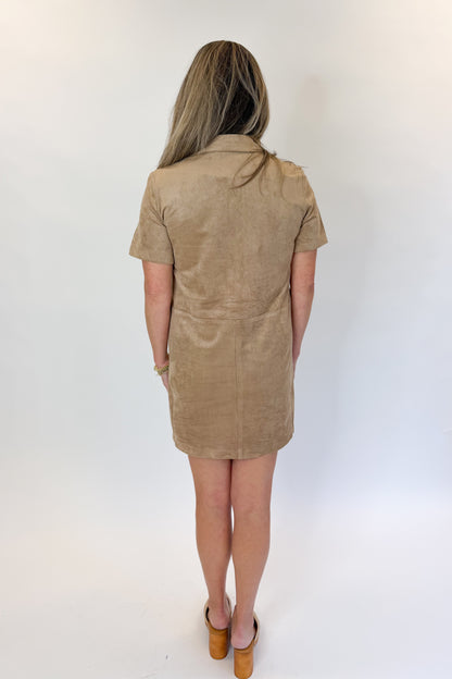 Back view of woman wearing Swagger Boutique’s Light Sand Leone Suede Mini Dress by Zsupply against white studio background.
