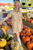 Front view of woman wearing Swagger Boutique’s Light Sand Leone Suede Mini Dress by Zsupply standing at a pumpkin patch.