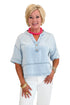 Front view of woman wearing Swagger Boutique’s Light Wash Denim V-Neck Top with jeans against white studio background.