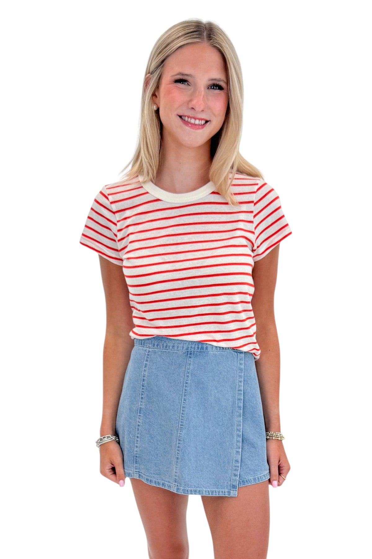 Front view of woman wearing Swagger Boutique’s Lychee Junie Striped Tee by Z Supply with Light Wash Denim Wrap Skort against white studio background.