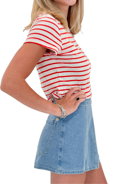 Side detail view of woman wearing Swagger Boutique’s Lychee Junie Striped Tee by Z Supply with Light Wash Denim Wrap Skort against white studio background.