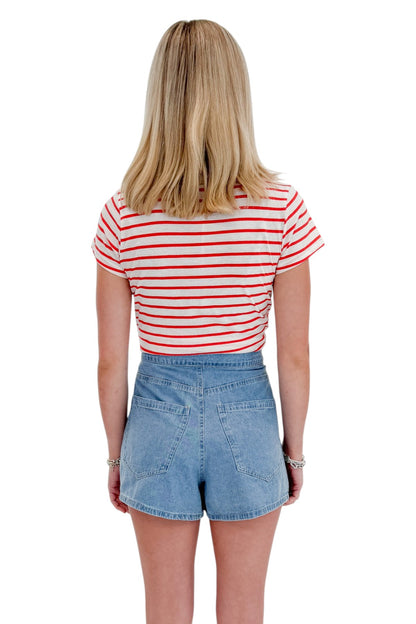 Back view of woman wearing Swagger Boutique’s Lychee Junie Striped Tee by Z Supply with Light Wash Denim Wrap Skort against white studio background.