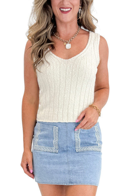Front detail view of woman wearing Swagger Boutique’s Light Wash Embroidered Pocket Skirt with sweater against white studio background.