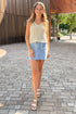 Front view of woman wearing Swagger Boutique’s Light Wash Embroidered Pocket Skirt with sweater walking outside.