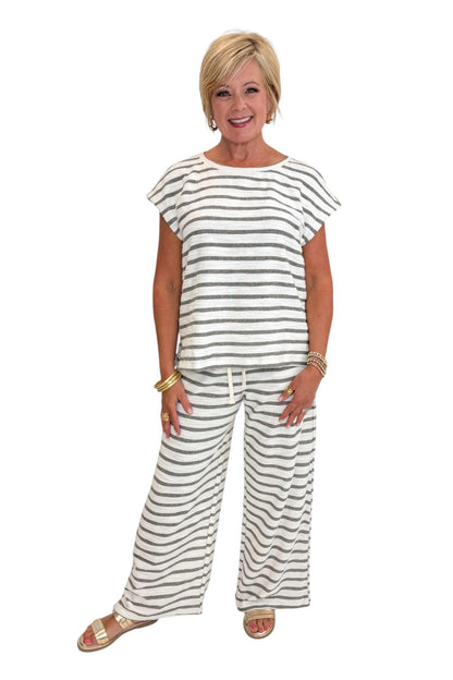 Front view of woman wearing Swagger Boutique’s Light Grey Striped Short Sleeve Top with matching Light Grey Striped Lounge Pants against white studio background.