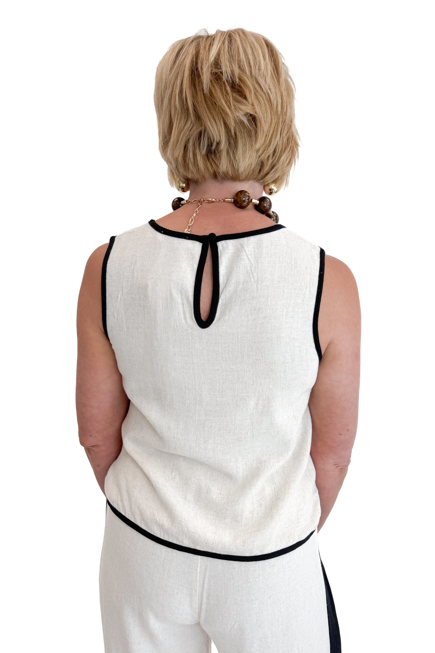 Back view of woman wearing Swagger Boutique’s Linen &amp; Black Lined Tank with matching Linen &amp; Black Stripe Pants against white studio background.