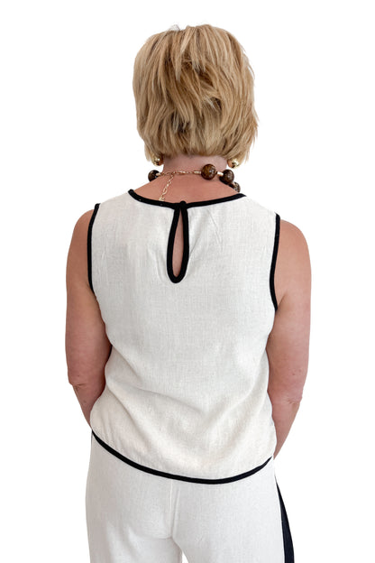 Back view of woman wearing Swagger Boutique’s Linen &amp; Black Lined Tank with matching Linen &amp; Black Stripe Pants against white studio background.