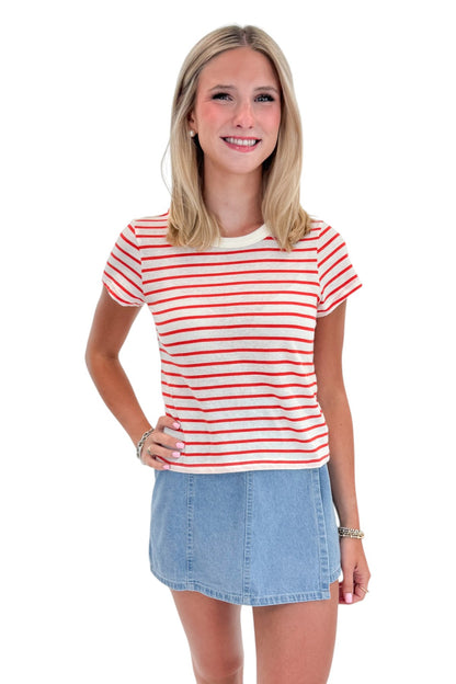 Front view of woman wearing Swagger Boutique’s Lychee Junie Striped Tee by Z Supply with Light Wash Denim Wrap Skort against white studio background.