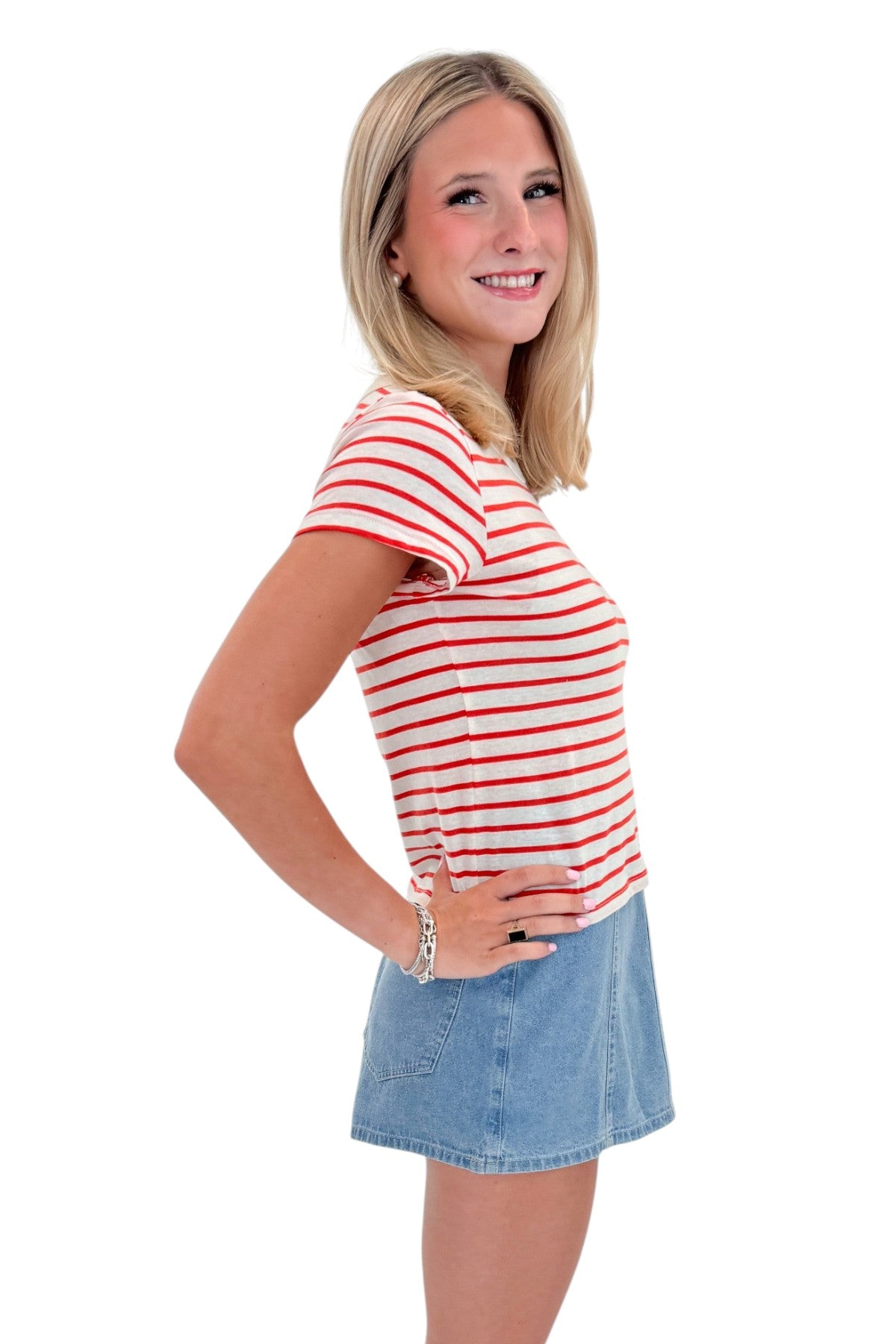 Side view of woman wearing Swagger Boutique’s Lychee Junie Striped Tee by Z Supply with Light Wash Denim Wrap Skort against white studio background.