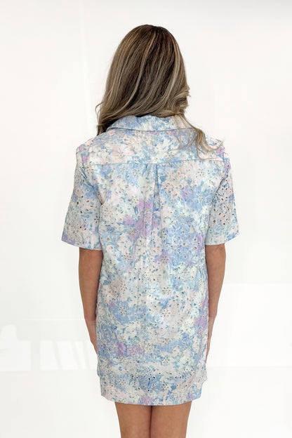 Back view of woman wearing Blue and Multi Eyelet Collared Dress with sandals against white studio background.