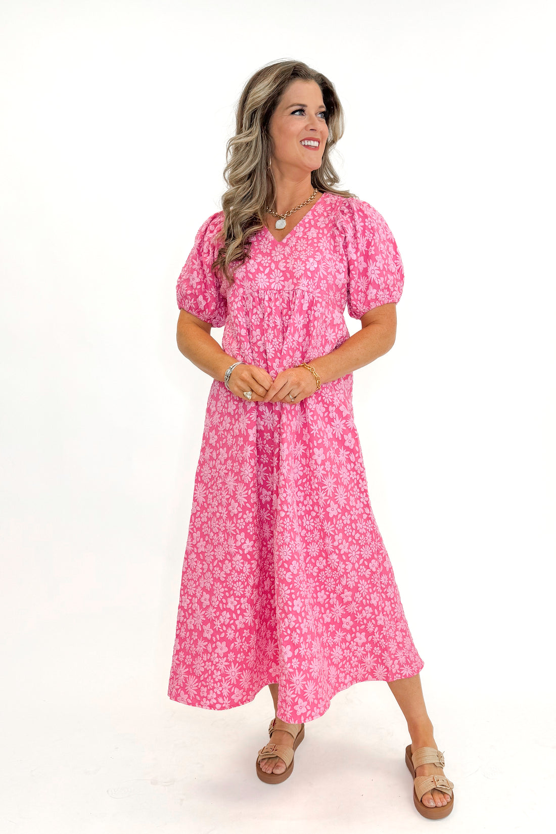 Front view of woman wearing Pink Floral Textured Puff Sleeve Midi Dress against white studio background.